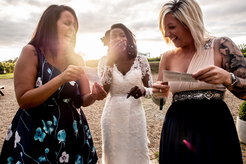 Candid wedding photography of the bridal party enjoying themselves during a wedding at Highdown Vineyard in West Sussex. Taken by Bristol wedding photographer, Darren Lehane.
