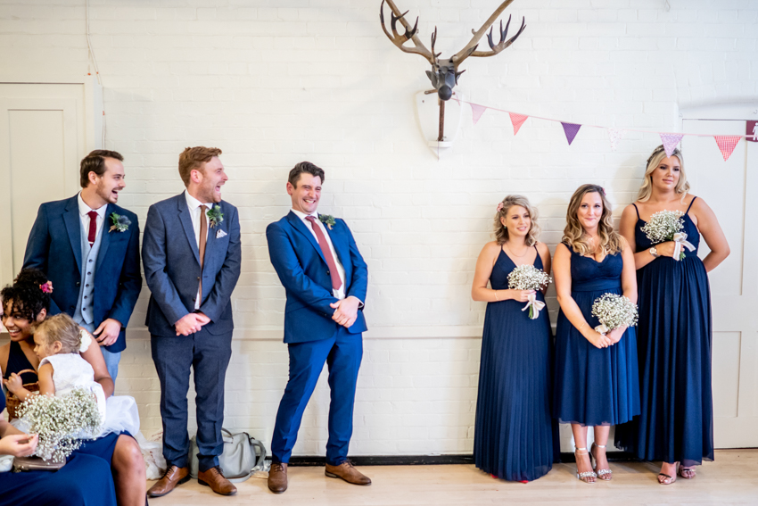 Candid wedding photography of the wedding party laughing during the wedding at Cecil Sharp House in London. Taken by Bristol wedding photographer, Darren Lehane.
