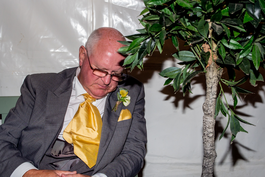 Documentary wedding photography of the father-of-the groom asleep during a wedding at Grendon Lakes, Northants. Taken by Bristol wedding photographer, Darren Lehane.