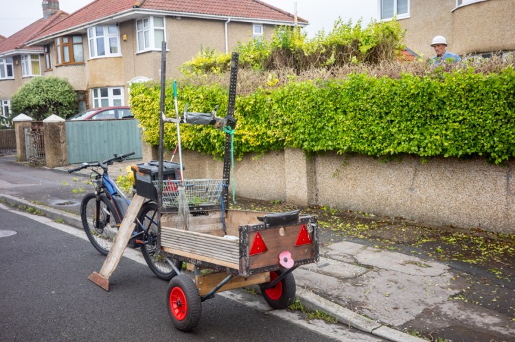 Candid street photography of a man behind a hedge in Weston-super-Mare, North Somerset.