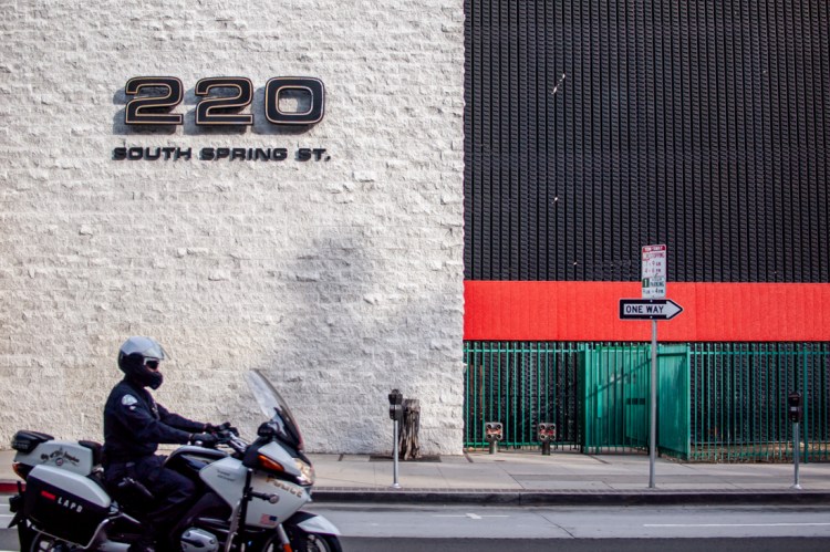 Candid street photography of a LAPD motorcyclist on a street in Los Angeles, USA.