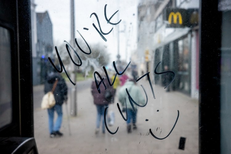 Handwritten message, "You're All Cunts" on a telephone box in Weston-super-Mare, North Somerset. Candid street photography by Darren Lehane