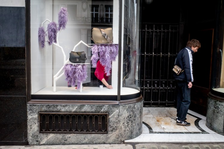 An arm in a shop window on Regent Street, London. Candid street photography by Darren Lehane