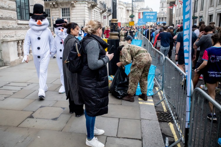 Snowmen walk along The Mall in London. Candid street photography by Darren Lehane