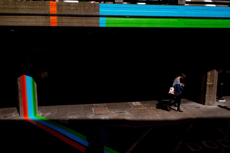 A person walks through a shard light on London's South Bank.