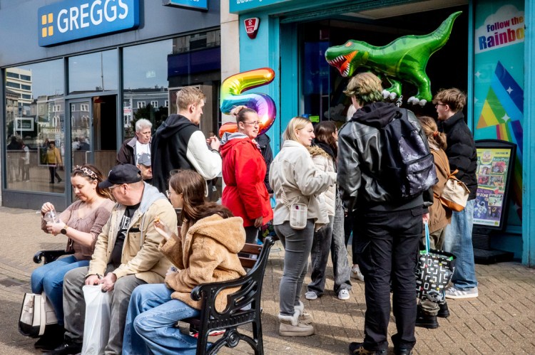 People gather on Weston-super-Mare High Street, with an inflatable Dinosaur.