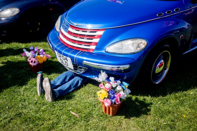 Candid street photography of legs sticking out from underneath a car in Weston-super-Mare.