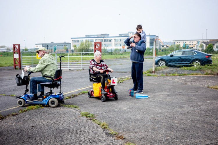 Candid street photography of a woman on a mobility scooter with L plates, in Weston-super-Mare