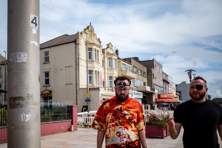 Candid street photography of a man with a pirate eyepatch on his forehead, in Weston-super-Mare.