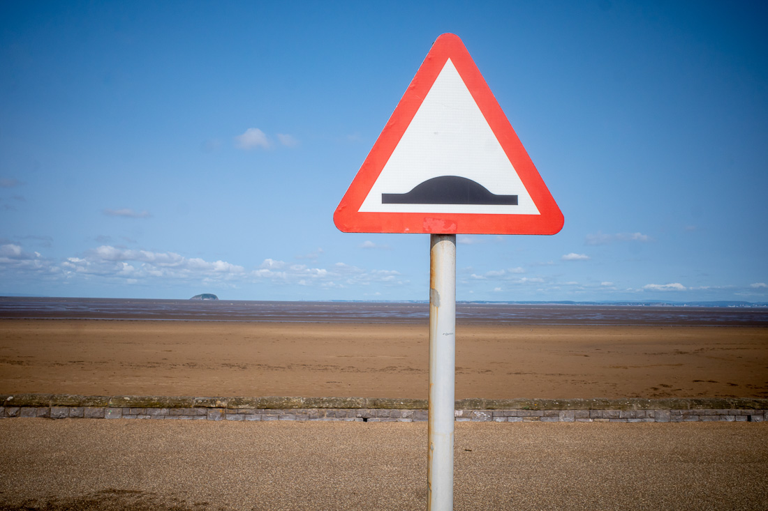 Candid street photography of a road sign and Steepholm island in Weston-super-Mare.