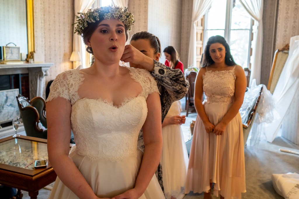 An apprehensive bride during the bridal preparations at Grittleton House in Wiltshire.