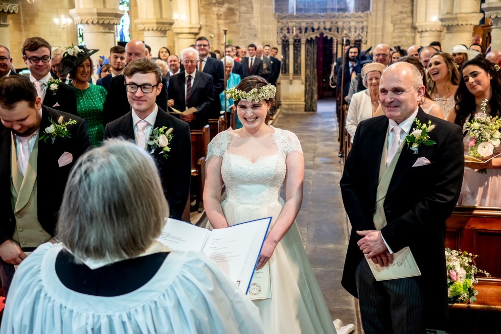 The couple laugh during the wedding ceremony at Grittleton House in Wiltshire.