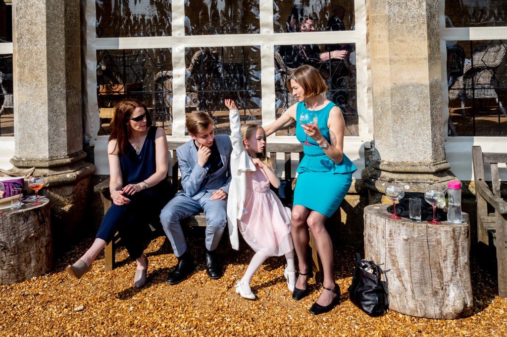 Wedding guests relaxing outside at Grittleton House in Wiltshire.