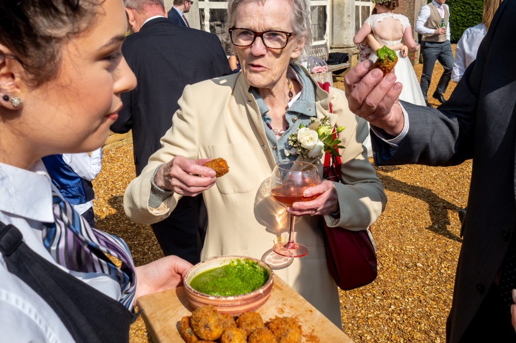 Wedding guests enjoying canapés at Grittleton House in Wiltshire.