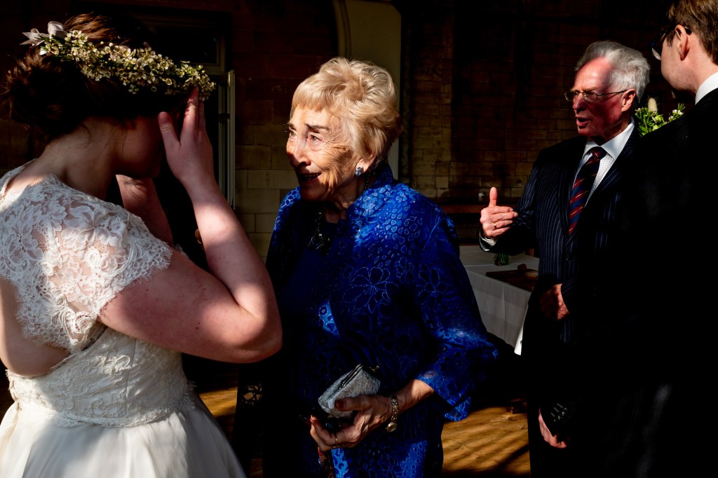Guests chat with the bride during a wedding at Grittleton House in Wiltshire.
