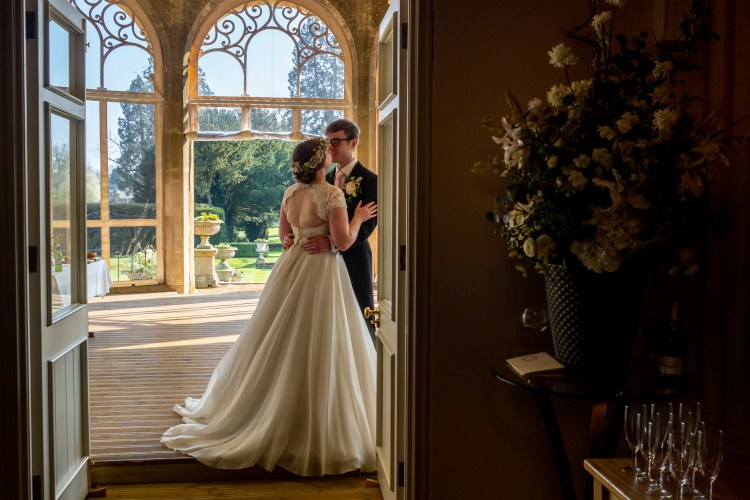 The couple embrace ahead of the wedding breakfast at Grittleton House in Wiltshire.
