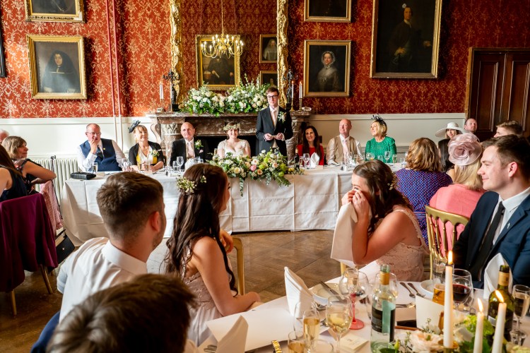 Guests are amused during the groom's wedding speech at Grittleton House in Wiltshire.
