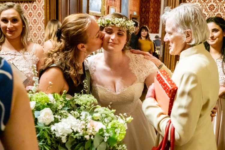 Guests kiss the bride during a wedding at Grittleton House in Wiltshire.