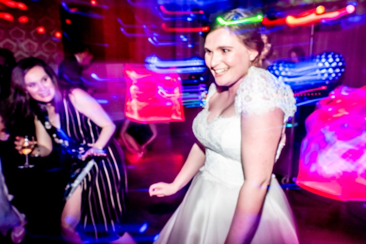 The bride laughs on the dancefloor at Grittleton House in Wiltshire.