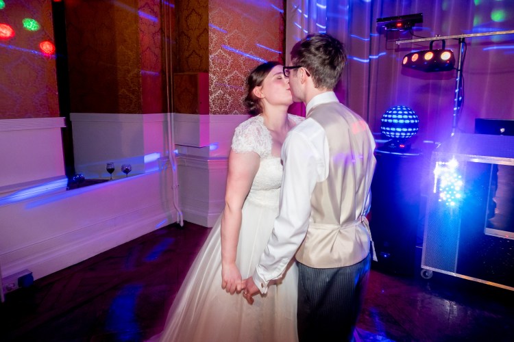 The bride and groom kiss during the evening wedding reception at Grittleton House in Wiltshire.