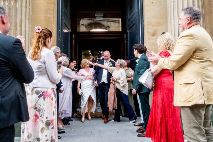 Guests throw confetti at the bride and groom after a wedding at Bristol Register Office in Bristol.