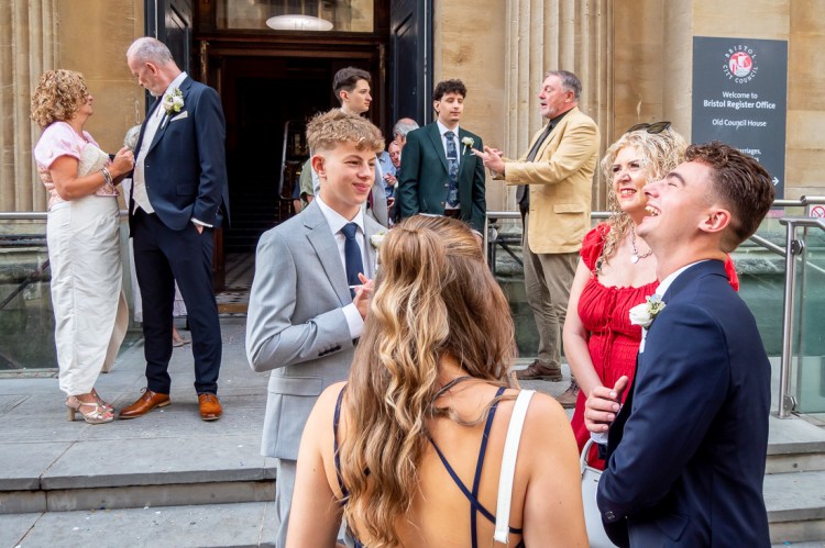 Wedding guests chatting and laughing after a wedding at Bristol Register Office in Bristol.