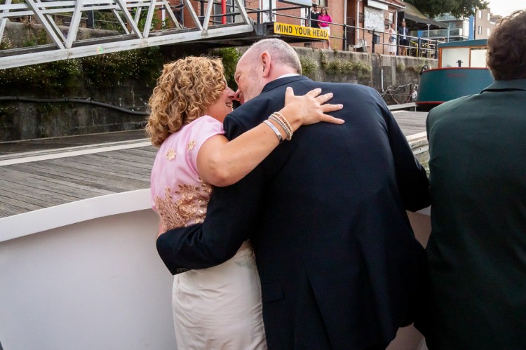The bride and groom kiss, during a Bristol wedding on the Flower of Bristol boat, run by Bristol Packet tour company.