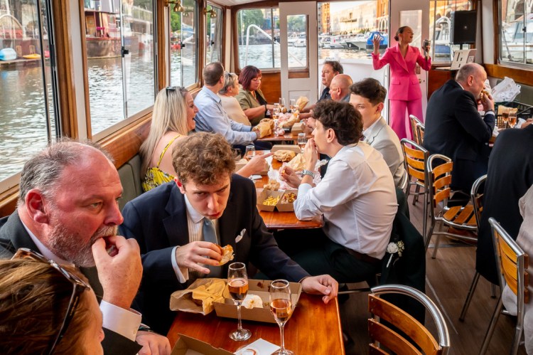 Guests enjoy the food, and wedding singer, during a Bristol wedding on the Flower of Bristol boat, run by Bristol Packet tour company.