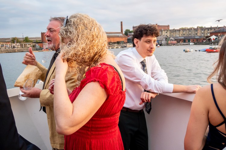 A guest sniffs her hair during a Bristol wedding on the Flower of Bristol boat, run by Bristol Packet tour company.