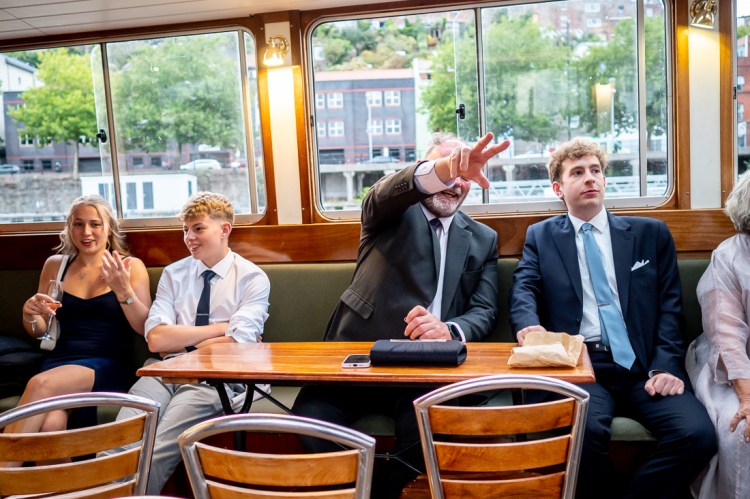 A guest points something out during a Bristol wedding on the Flower of Bristol boat, run by Bristol Packet tour company.