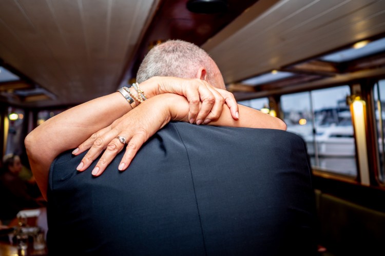 The bride and groom embrace during a Bristol wedding on the Flower of Bristol boat, run by Bristol Packet tour company.