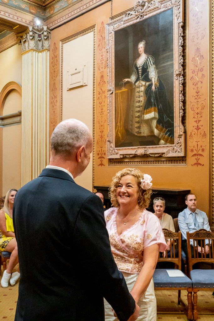 The bride and groom look at one another during the wedding ceremony at Bristol Register Office, on Corn Street in Bristol.