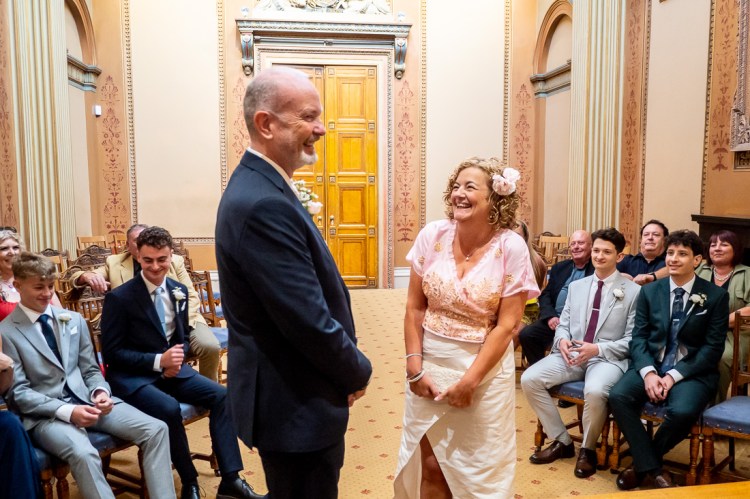 The bride and groom laugh during a ceremony at a wedding at Bristol Register Office in Bristol.
