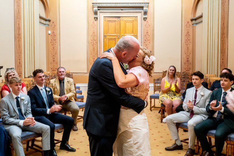 The bride and groom enjoy their first kiss during a wedding at Bristol Register Office in Bristol.