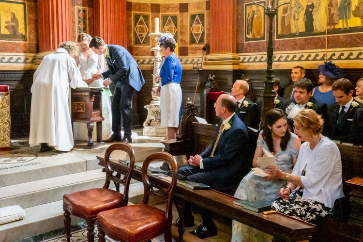 The bride and groom sign the wedding register during a wedding at Worcester College in Oxford.