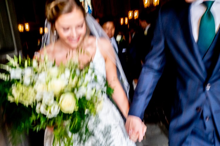 The bride and groom leave the ceremony during a wedding at Worcester College in Oxford.