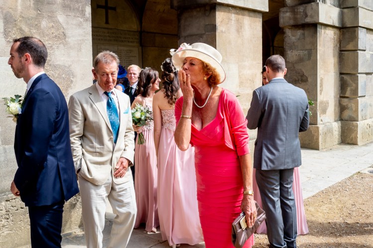 A guest blows a kiss during a wedding at Worcester College in Oxford.