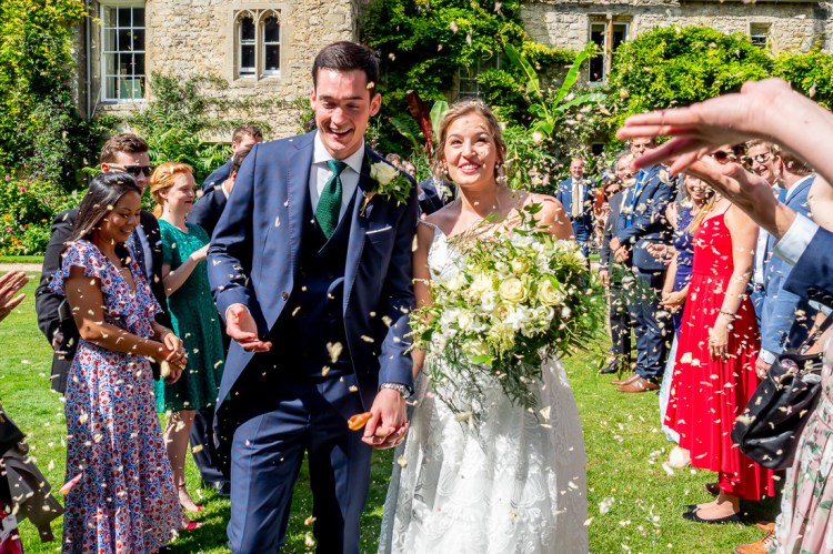 Guests shower the bride and groom with confetti, during a wedding at Worcester College in Oxford.