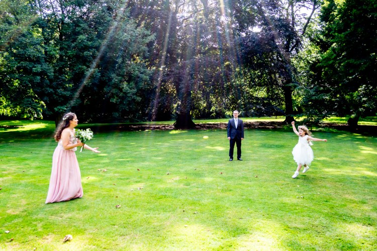 The flower girl has fun during a wedding at Worcester College in Oxford.