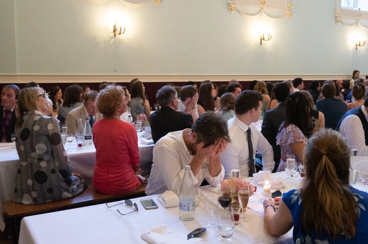 A guest looks bored during the speeches at a wedding at Worcester College in Oxford.