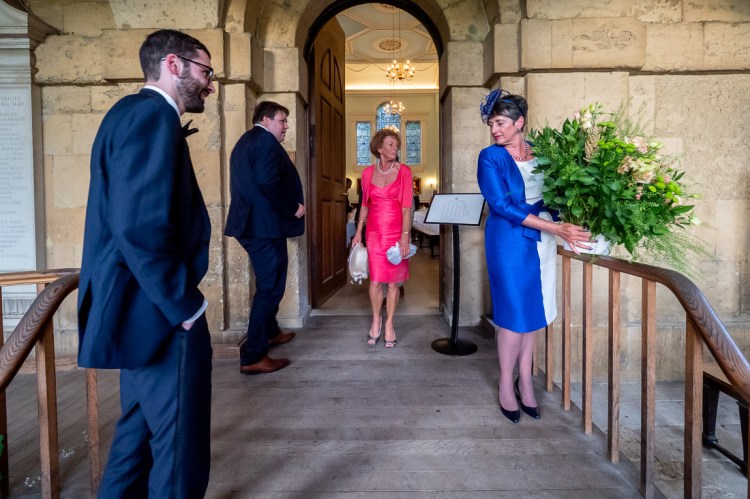 The Mother-of-the Groom with flowers during a wedding at Worcester College in Oxford.