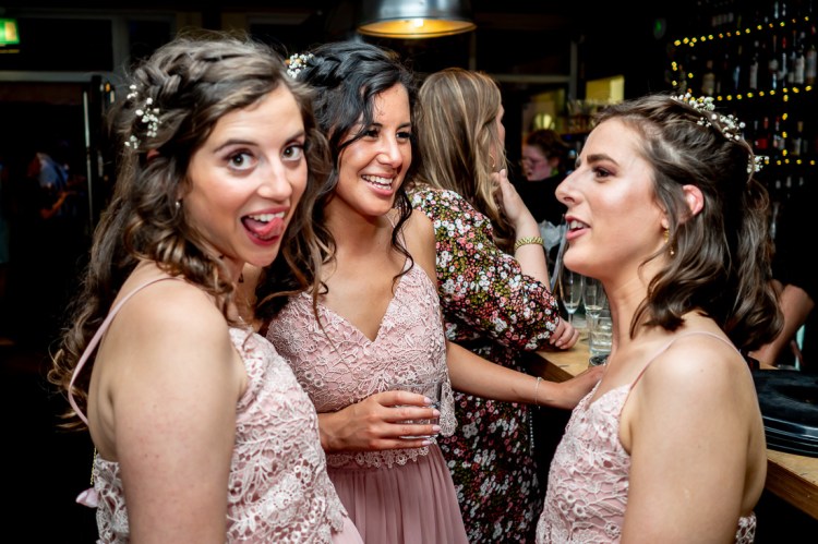 Bridesmaids have fun during the evening wedding reception at the Jam Factory in Oxford.