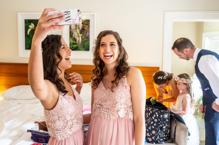 Bridesmaids take a selfie during the morning preparations, before a wedding at Worcester College in Oxford.