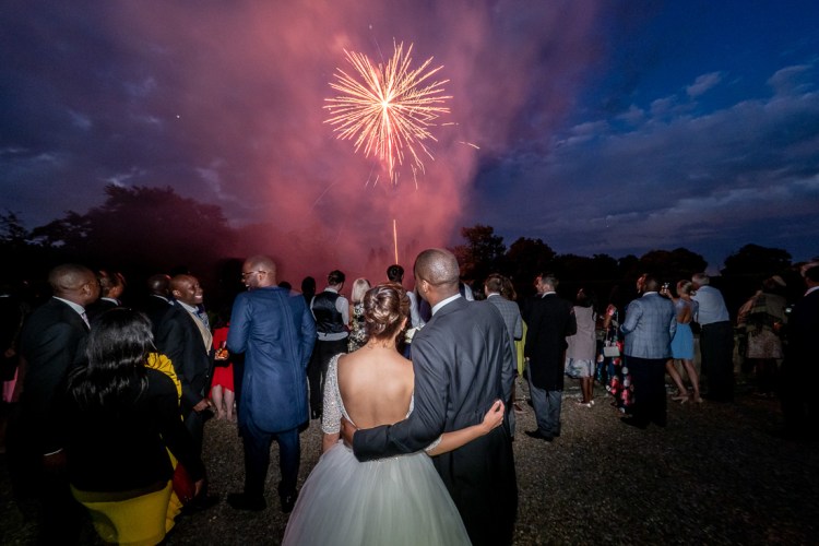 The bride and groom watch fireworks during a wedding at Ashby Manor House in Northants.