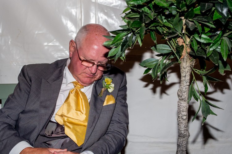 A sleepy wedding guest during a wedding at Grendon Lakes in Northamptonshire.