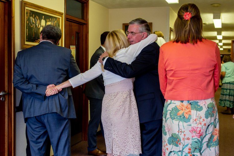 Guests embracing after a Mormon wedding in Worthing, West Sussex.