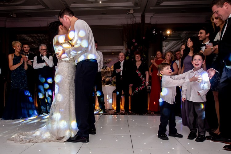 Young guests beside the bride and groom, during their first dances at a wedding at the Hyatt Regency London - The Churchill hotel in central London.