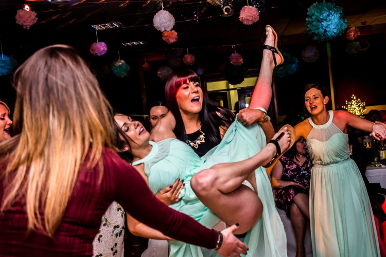 A drunk bridesmaid on the dancefloor, during a wedding at the Holy Ghost in Luton, Bedfordshire.