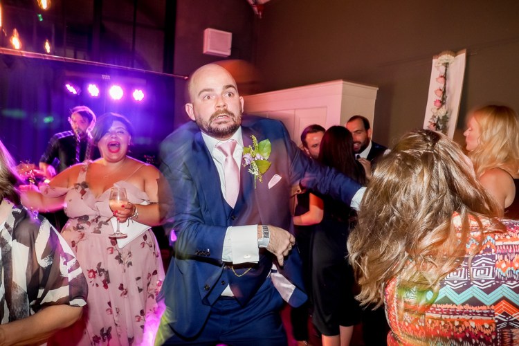 A groom on the dancefloor during a wedding in Borough, London.