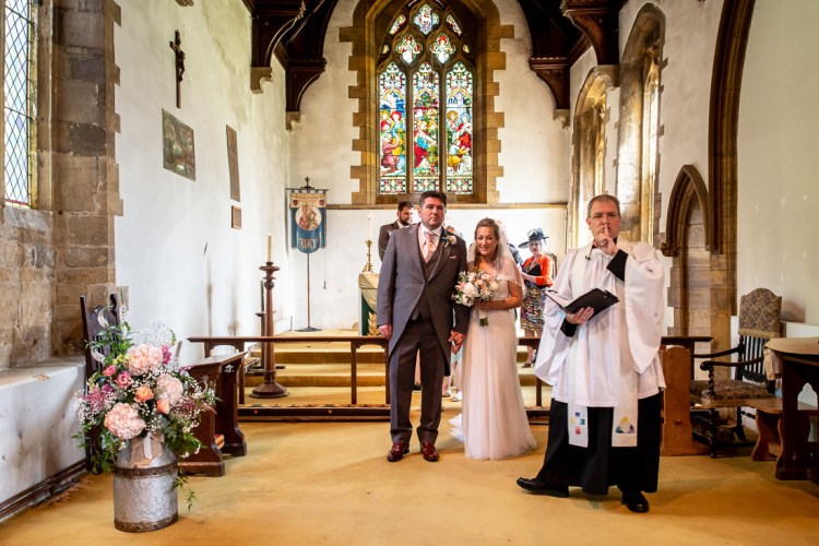 The vicar silences the congregation during the wedding ceremony in Nether Heyford, Northants.